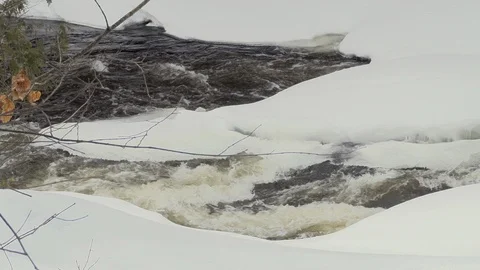 Close-up of a river covered by snow in a forest Stock Footage 109286633