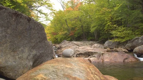 CLOSE UP: River flows into ravine with pools, rapids and huge rocks in riverbed Stock Footage 80691748