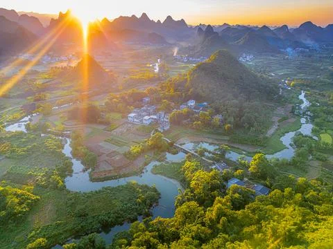 Close up on the river going through the village and karst mountains in Wuzh.. Stock Photos