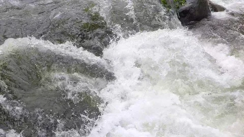 Close up river rapid, pan down closer to the whitewater Stockbeeldmateriaal 93386292