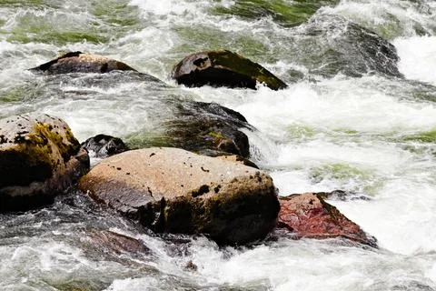 Close-up of river rocks surrounded by rushing water near Snoqualmie Stock Photos