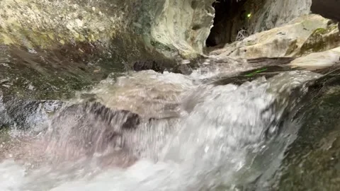 Close-Up of River Water Flowing Inside Zugarramurdi Cave Stock Footage 323115840