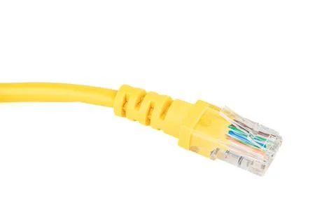 Close-up of the RJ-45 network connection plug of the yellow Ethernet cable of Stock Photos