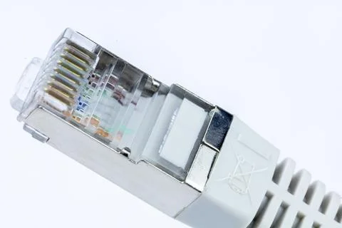 Close-up of an RJ45 network cable connector, showcasing its internal wiring.. Stock Photos
