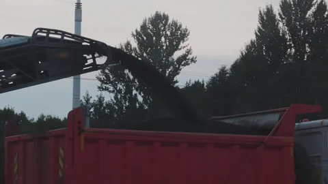 Close up of a road milling machine conveyor loading old crushed asphalt Stock Footage 345879557