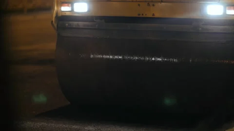 A close-up of a road roller drum. Steam from fresh asphalt. Road repair, new Stock-Footage 154482382