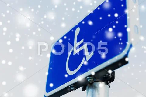 Close up of road sign for disabled over snow Stock Photos