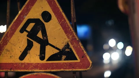 Close-up of a road sign warning drivers about road works. Grunge road traffic Stock Footage 154710799