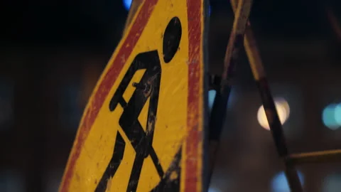 Close-up of a road sign warning drivers about road works. Grunge road traffic Stock Footage 154732334