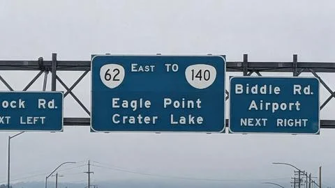 Close-up of road signs pointing to Eagle Point and Crater Lake Stock Photos