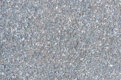 Close up road surface with pebble stone in concrete floor texture background. Stock Photos
