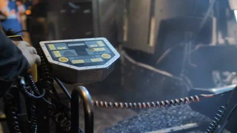 Close-up of a road worker clicks on the buttons on the paver's control panel Video stock 195292187