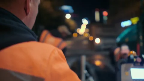 A close-up of a road worker at the control panel of an asphalt paver. Road Stock Footage 154709932