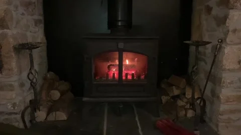 Close up of a roaring fire in a wood burning stove or log burner. Stock Footage 246378246