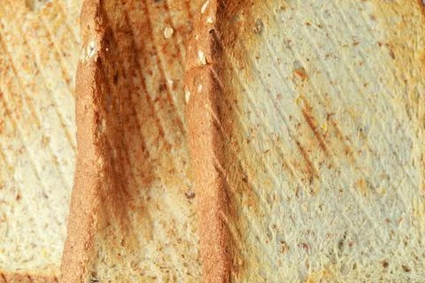 Close up roasted bread background texture. Macro photo top view. Stock Photos