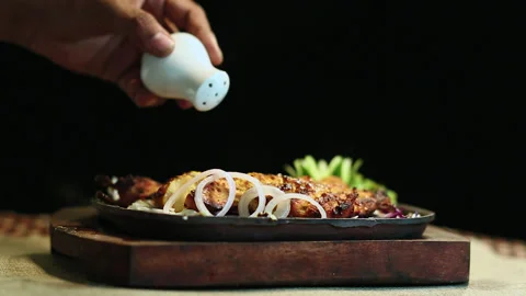 Close-Up Roasted Chicken BBQ Sprinkle with Salt Black Background Stock Footage 200953948