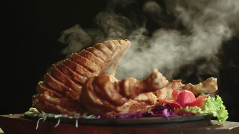 Close Up of Roasted Chicken on Round Table with Smoke Black Background Stock Footage 200953359