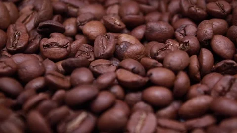 Close Up of Roasted coffee bean. Fragrant coffee seeds are falling Stock Footage