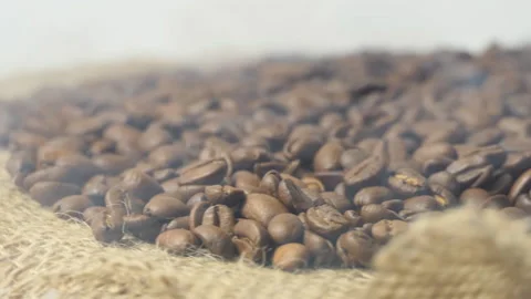 Close-up of roasted coffee beans. Aromatic coffee beans are roasted smoke coming Stock Footage 195447806