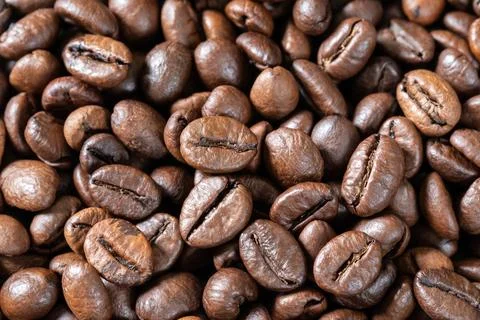 Close-up of roasted coffee beans, background, texture. Good mood. Coffee aroma Stock Photos