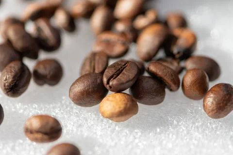 Close up of roasted coffee beans on a bright reflective surface Fotos de archivo