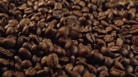 Close up of roasted coffee beans falling and piling up. 動画素材 336982979