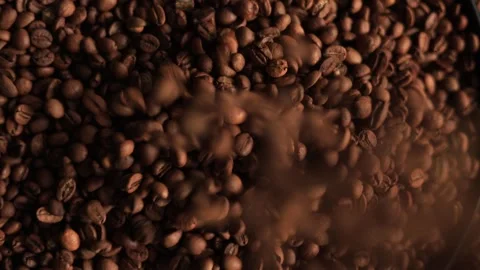 Close-up of roasted coffee beans falling and tumbling in slow motion Stock Footage 338441324