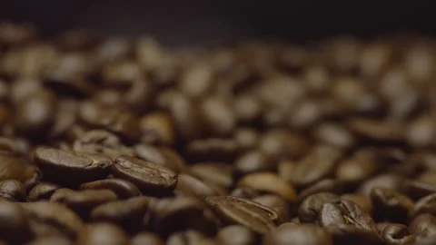 Close-up of roasted coffee beans in focus in rotation. Circular filming. Stock Footage 303424537