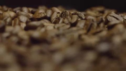Close-up of roasted coffee beans in focus in rotation. Circular filming. Stock-Footage 303424550