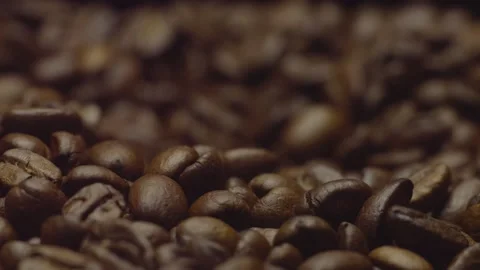 Close-up of roasted coffee beans in focus. Changing focus. Blurred background. Stock Footage 303424604