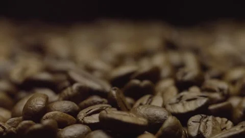 Close-up of roasted coffee beans in focus. Changing focus. Blurred background. Stock Footage 303424663