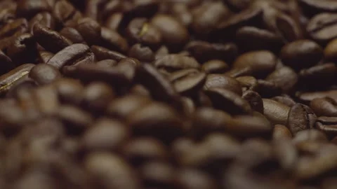 Close-up of roasted coffee beans in focus in rotation. Circular filming. Stock-Footage 303634685