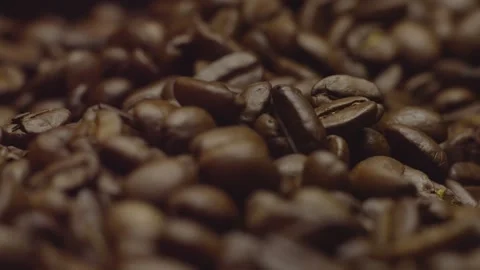 Close-up of roasted coffee beans in focus in rotation. Circular filming. Stock-Footage 303634798