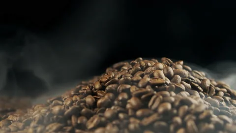 Close-up of roasted coffee beans. Fragrant coffee beans are roasted smoke comes Stock Footage 188661993