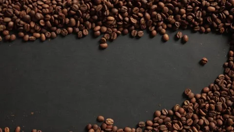 Close-up of Roasted Coffee Beans Poured and Hand Gesturing on Dark Surface 스톡 동영상 338441321