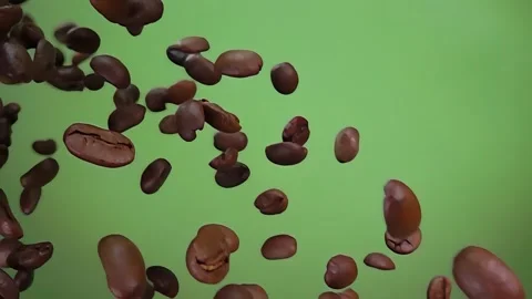 Close-up of the roasted coffee beans rotating on the olive green background Stock Footage 296582069