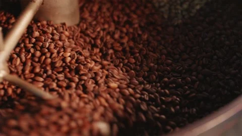 Close up of roasted coffee beans rotating in cooling tray Stock Footage 334732402
