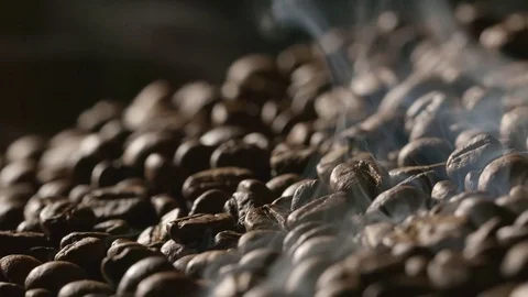 Close up of roasted coffee beans with a smoke Stock Footage
