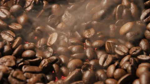 Close-up of roasted coffee beans. Smoke rises from the coffee beans. Stock Footage 263065613