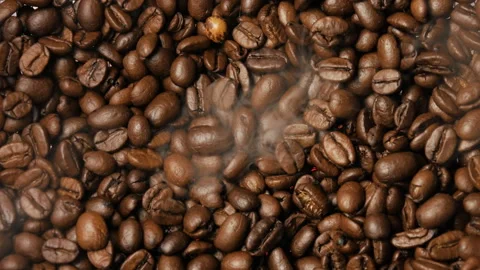 Close-up of roasted coffee beans. Smoke rises from the coffee beans. Stock Footage 263339789