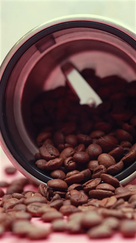 A Close-Up Of Roasted Coffee Beans Spilling From A Grinder. Vertical. Stock Footage 295292283
