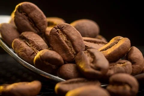Close-up of Roasted Coffee Beans in a Spoon Stock Photos