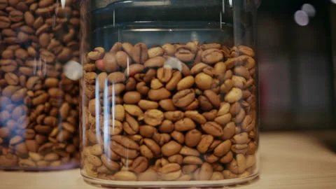Close up of roasted coffee beans stored in a transparent container Stock Footage 332611535