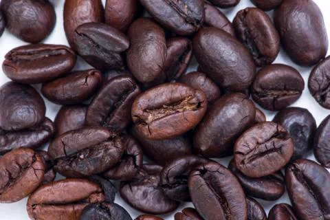 Close up roasted coffee beans on white Stock Photos