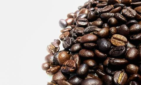 Close-up roasted coffee beans on white background with copy space. Abstract.. Stockfoto's