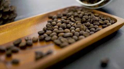 Close up roasted coffee beans on the wooden tray. Coffea excelsa. Stock Footage 219857787