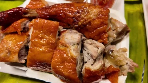 Close-Up of Roasted Duck Portions with Crispy Skin at Thai Night Market Stock Footage 335998859