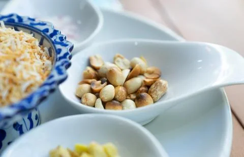 Close up roasted peanut on white spoon for miang kum ingredient Stock Photos