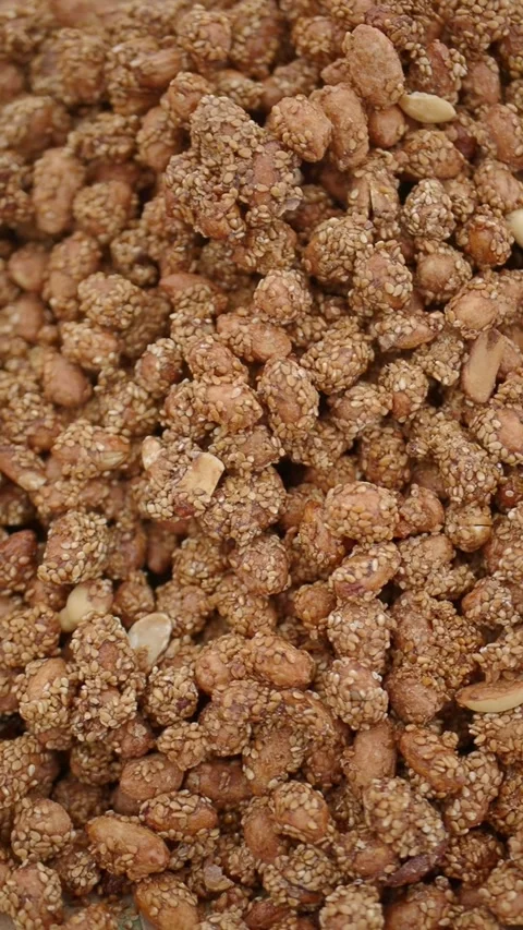 Close-up of Roasted Peanuts Coated with Sesame Seeds Stock Footage 341786107