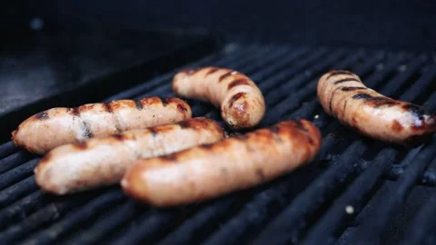 Close up of roasting hot dogs on BBQ, 4K Stock Footage 137016189